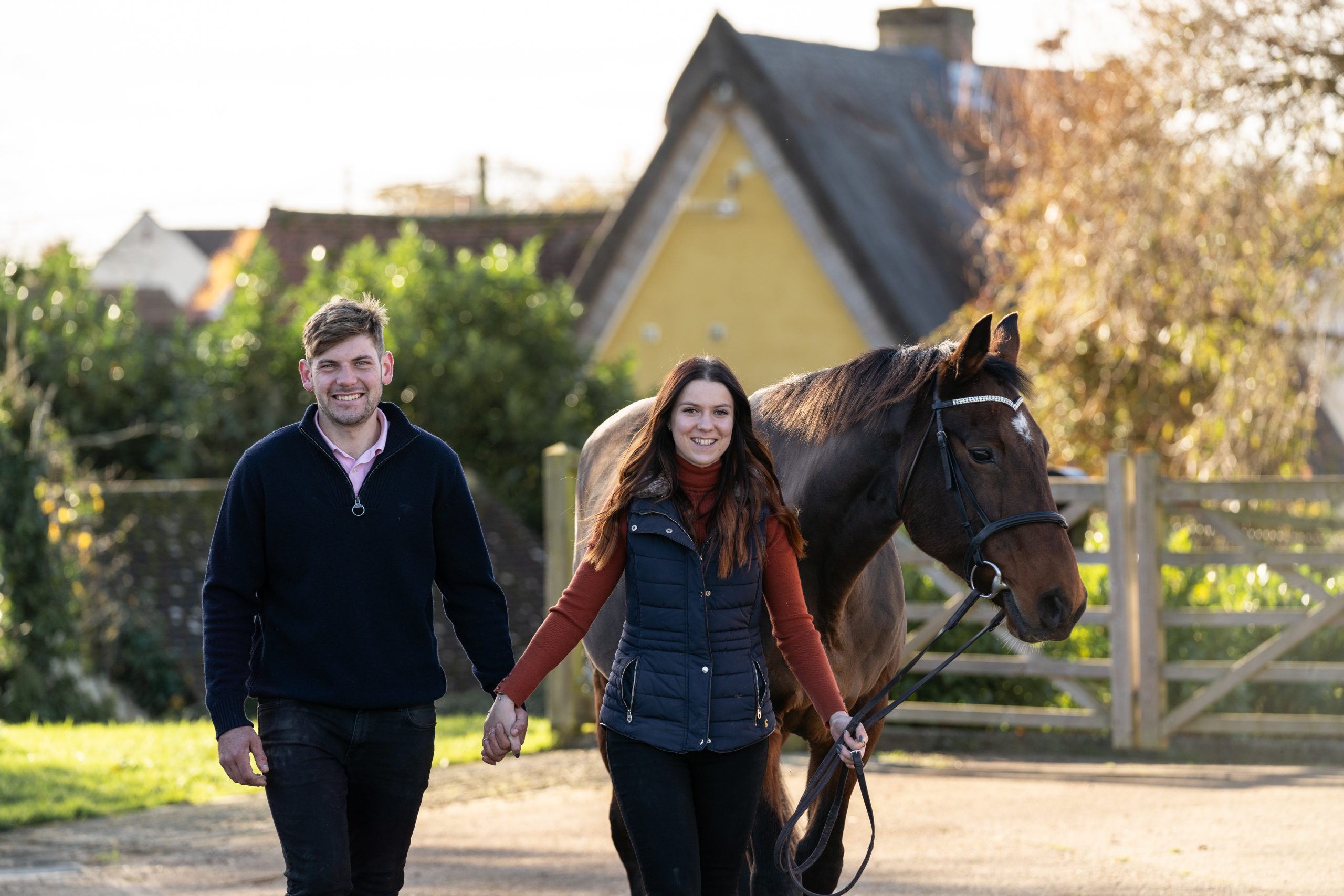 Samantha and James and their horse doodles walking towards the camera on their photoshot